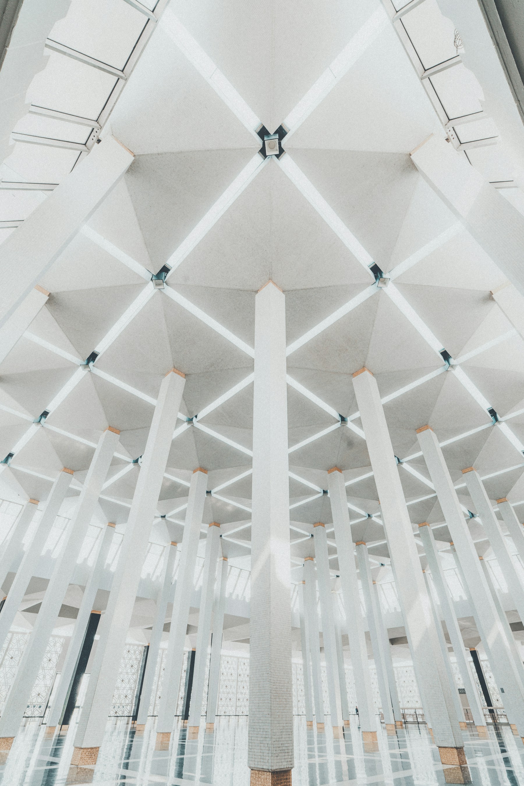 Geometric white ceiling and architectural columns