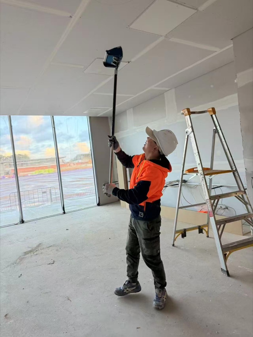 Team member finishing a plasterboard ceiling