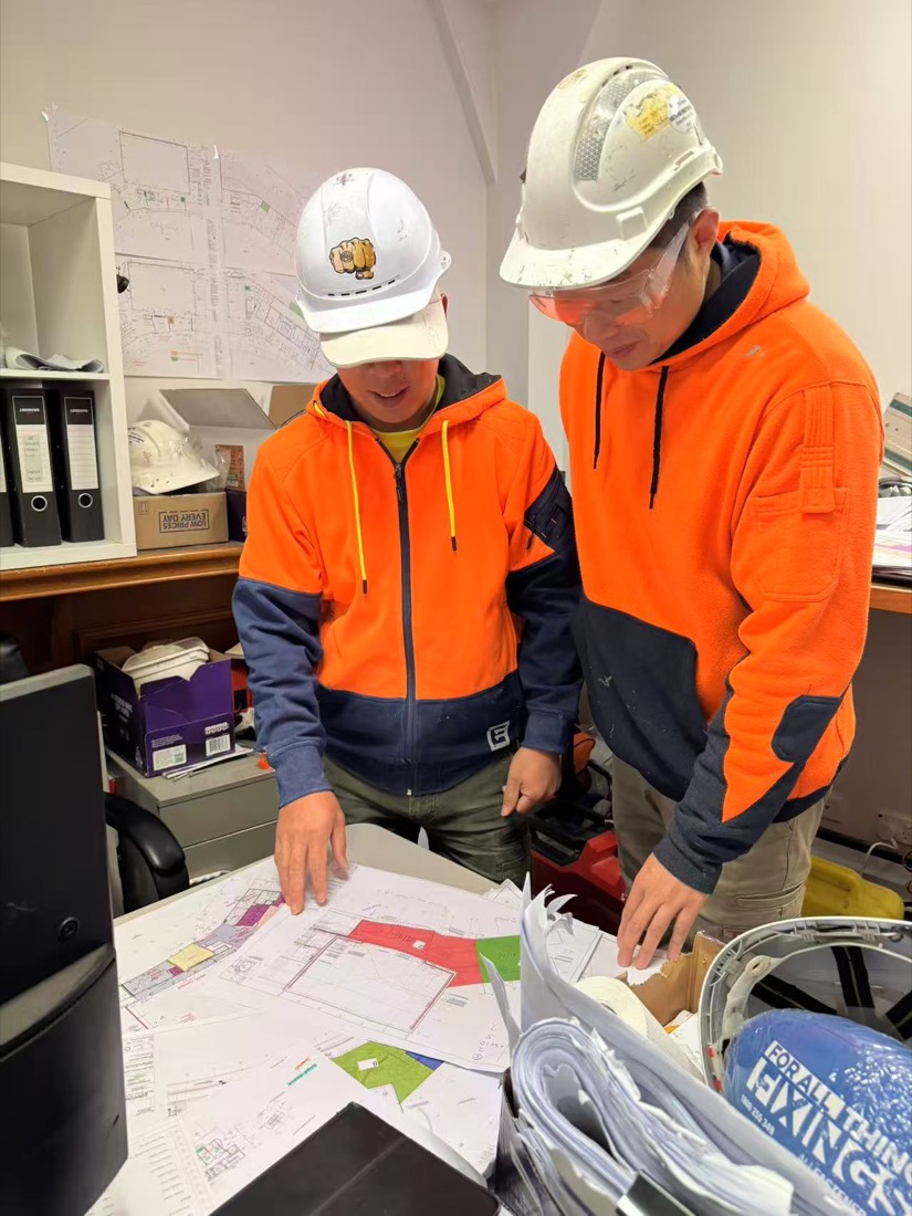 EM PROJECT team reviewing plans
